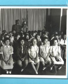 Pupils, as film show audience, labelled 1955