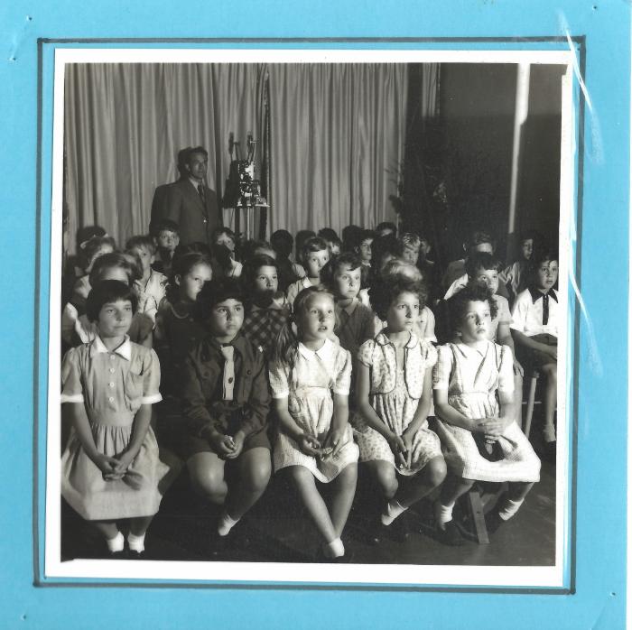 Pupils, as film show audience, labelled 1955