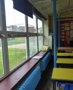 Classroom with original radiators and showing windows and piloti