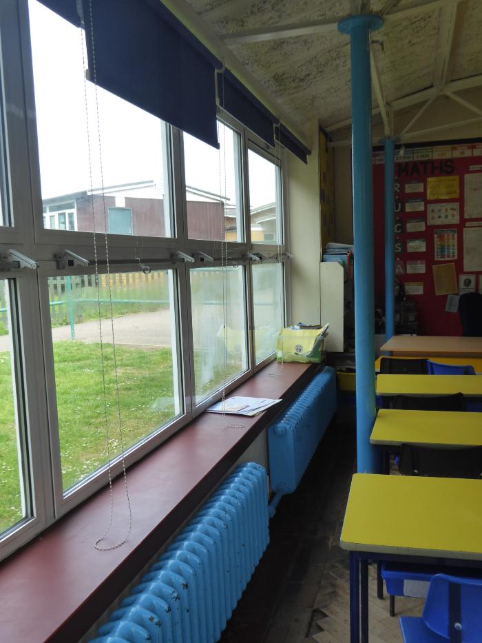Classroom with original radiators and showing windows and piloti